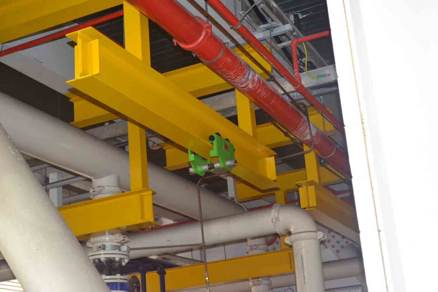 Industrial pipework and structural supports installed inside a factory