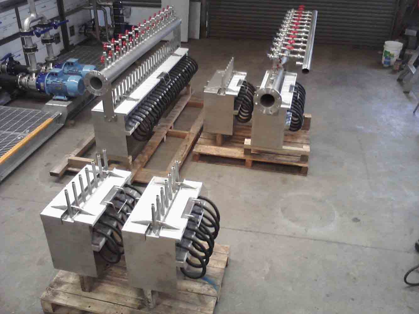 Multiple stainless steel manifold assemblies in the workshop